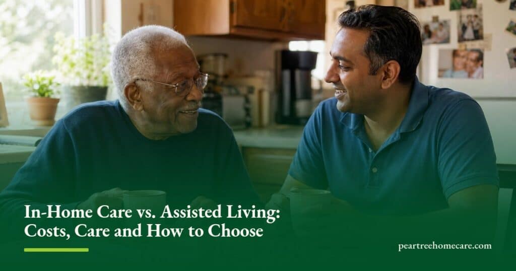 A caregiver and an older man laugh together over tea at his sunlit kitchen table at home.